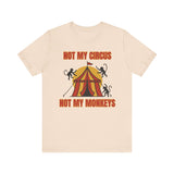 “Front of Christian humor shirt with circus tent, monkeys, and the text ‘Not My Circus, Not My Monkeys’ in red and gold