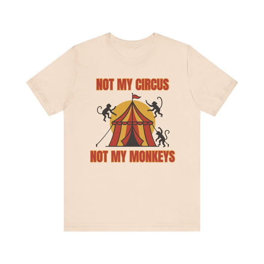“Front of Christian humor shirt with circus tent, monkeys, and the text ‘Not My Circus, Not My Monkeys’ in red and gold