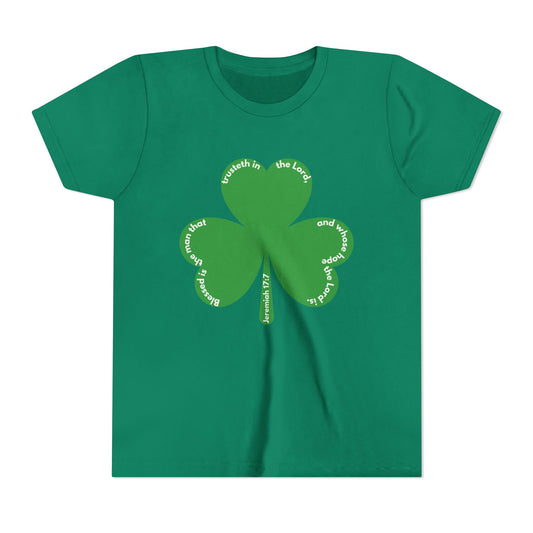 Front Youth green Christian t-shirt featuring a three-leaf clover with Jeremiah 17:7 Scripture text curved along each leaf, front view, St. Patrick’s Day faith shirt for kids.