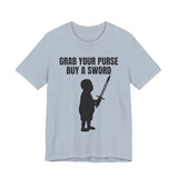 Front of light blue Christian t-shirt with black silhouette of a child holding a sword and bold text above reading ‘GRAB YOUR PURSE BUY A SWORD