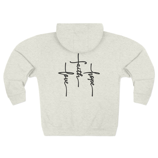 Back of an Oatmeal colored zip up hoodie featuring 3 Crosses with the words love faith and hope written into them.