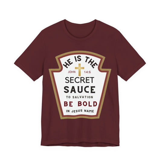Front: Maroon unisex Christian t-shirt with a ketchup-label style graphic reading “He Is the Secret Sauce to Salvation — Be Bold in Jesus Name” with John 14:6 cross emblem.